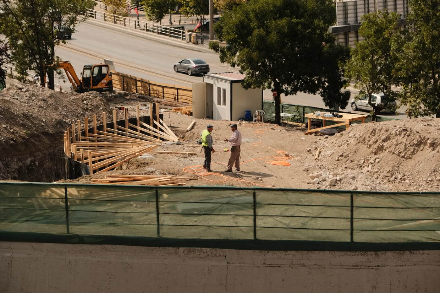Construction managers discussing plans at an active construction site
