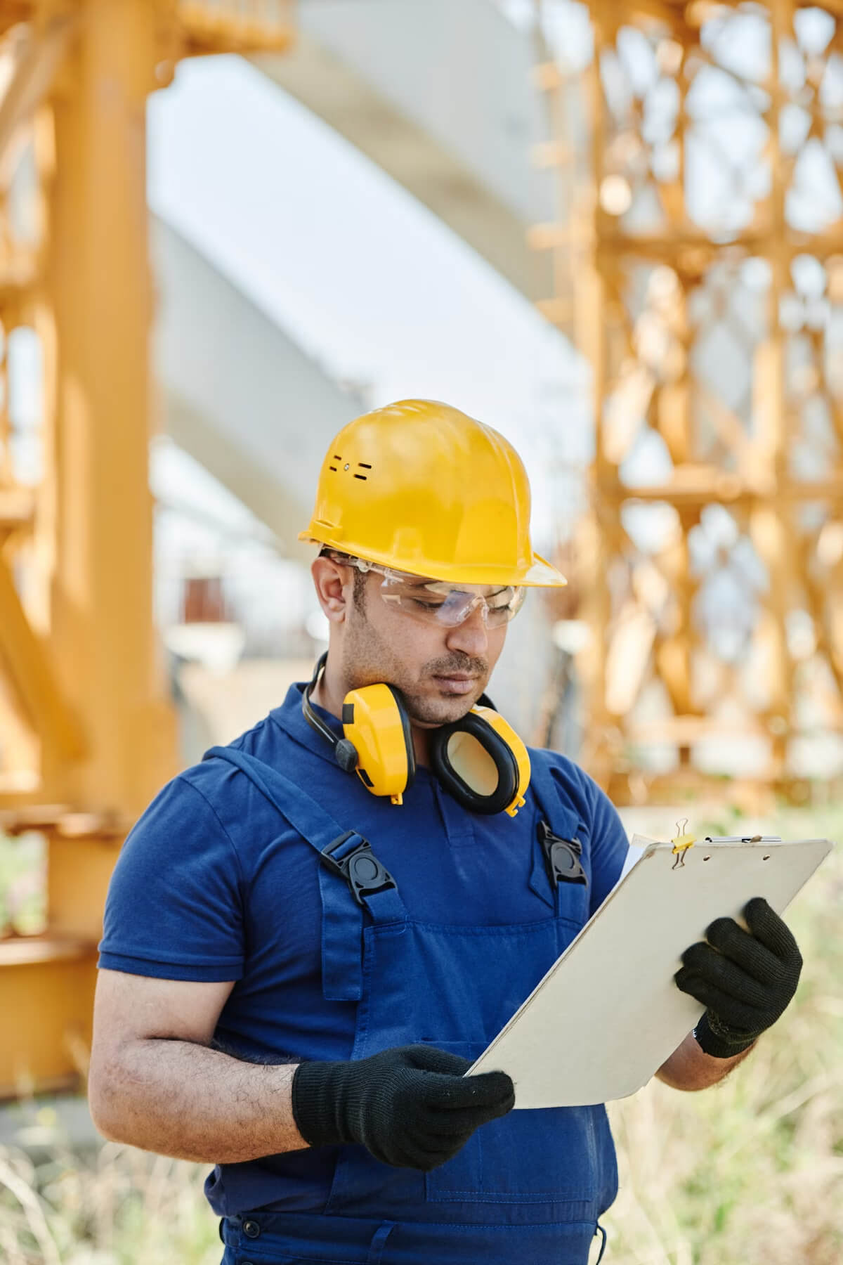 Construction manager reviewing site plans and project documentation on an active jobsite